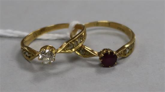 An 18ct gold and single stone diamond ring with diamond set shoulders and an en suite ruby and diamond ring, size K.